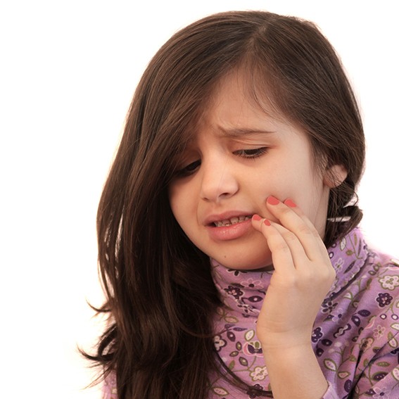 Little girl in purple shirt with tooth pain