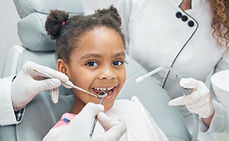 Child smiling during dental checkup