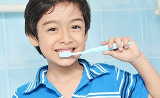 Mom and child smiling while eating snack in kitchen