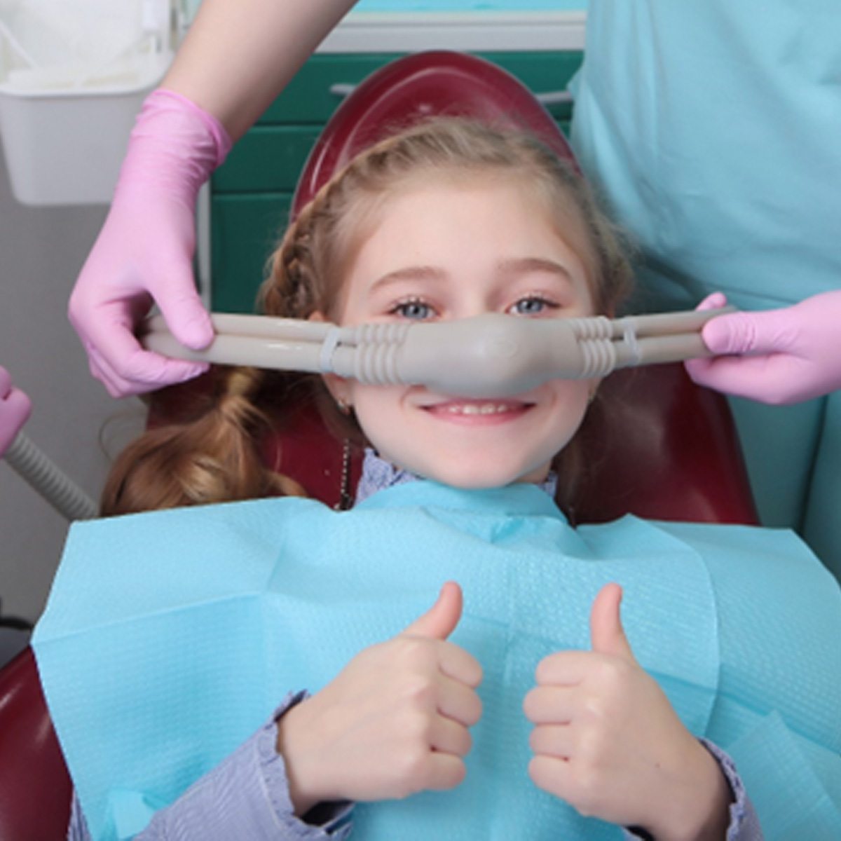  little girl receiving nitrous oxide sedation from her dentists