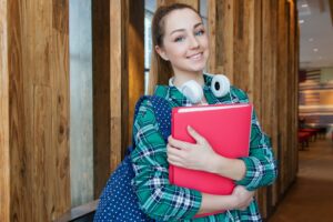 Female teenager holding a book