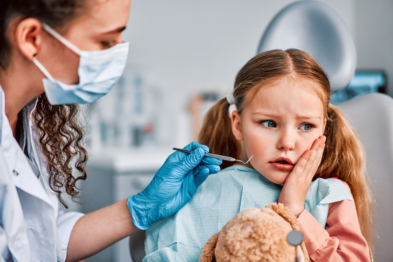 Young patient holding their cheek due to a toothache